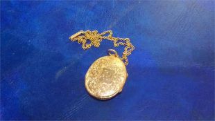 A 9ct gold oval locket with chain, weight 10.3 grams