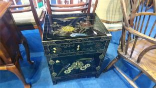 An Oriental lacquered two door cabinet, 50cm wide