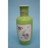 A Chinese famille rose vase, on a lime green ground. 25cm high