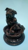 A small reproduction bronze of a bulldog and puppy in a basket