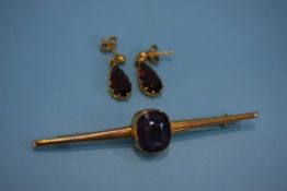 A 9ct gold and amethyst bar brooch and a pair of earrings