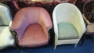 A pink upholstered tub armchair