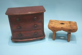 A small cracket and a miniature mahogany bow front three drawer chest of drawers, 32cm wide