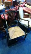 An ebonised carver chair