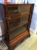 A mahogany three tier globe style bookcase with fluted and reeded pilasters, 101cm wide