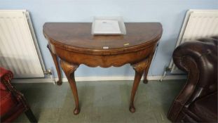 A walnut Queen Anne style demi lune fold over table, 108cm wide