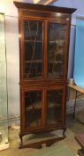 An Edwardian mahogany standing corner cabinet