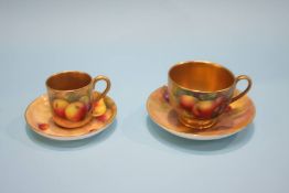 A Royal Worcester cup and saucer decorated with fruit, signed Albert Shuck and another, the cup