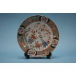 A Chinese circular plate decorated with flowers and birds, signed to base, 20cm wide
