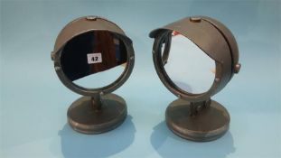 A pair of searchlight table mirrors