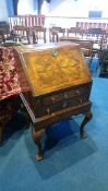 A good quality walnut Queen Anne style bureau, with fall front, below two drawers supported on