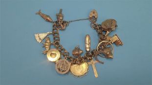 A gold charm bracelet with various charms, including a Victorian 1/2 sovereign (46.8 grams)