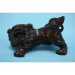 A carved hardwood netsuke in the form of a dog of Fo