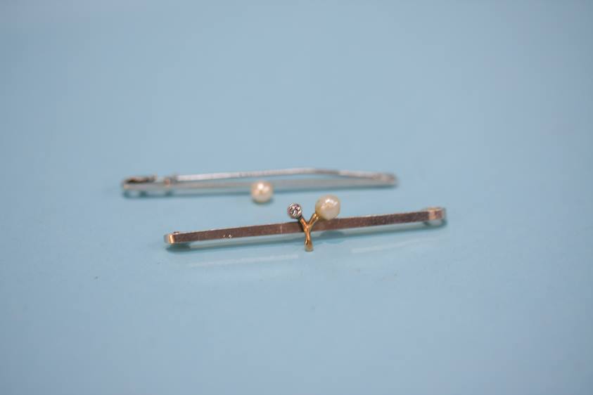 A 9ct white gold bar brooch, mounted with a pearl and one other
