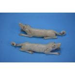 A pair of carved ivory dogs