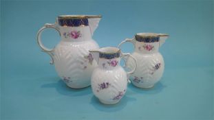 A set of three Coalport graduated jugs