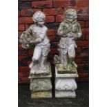Two garden statues on plinths