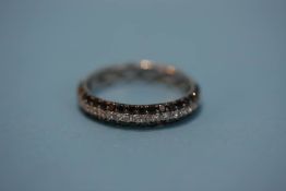 An 18ct (750) black and white diamond ring, size 2, 2.5 grams