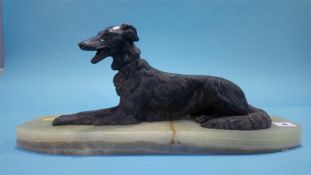 A model of a dog on an onyx base, 46cm length