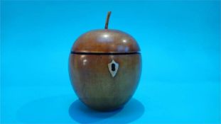 A reproduction apple shaped tea caddy