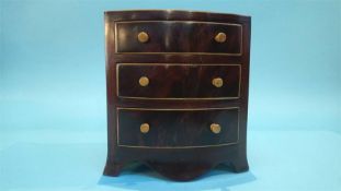 A miniature bow front chest of three drawers, 22cm wide