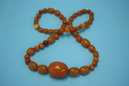 A string of egg yolk Amber coloured beads, 58 grams