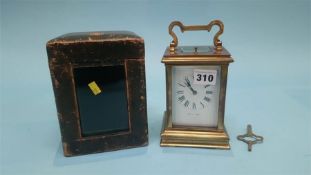 A brass carriage clock and fitted travelling case, the dial signed Lister and Son's