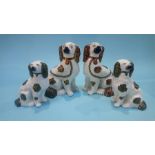 Two pairs of Staffordshire Spaniels, 23cm high and 17cm high