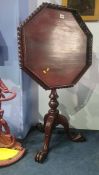 A reproduction mahogany octagonal tilt top occasional table, with pierced fretwork gallery, 60cm