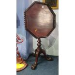 A reproduction mahogany octagonal tilt top occasional table, with pierced fretwork gallery, 60cm