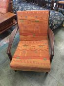 A pair of Guy Rogers style teak armchairs