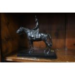 A bronze model of Her Majesty the Queen on horse back, 21cm wide, 22cm high