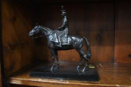 A bronze model of Her Majesty the Queen on horse back, 21cm wide, 22cm high