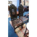 A pair of carved oak barley twist hall chairs, with cane back and seats