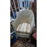 A cream Lloyd Loom chair