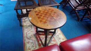 An oak chessboard top triangular table, 54cm diameter