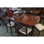 A mahogany gate leg dining table and 6 chairs.
