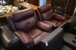 Two burgundy leather recliners