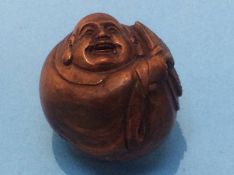 A carved netsuke in the form of a man holding a fan