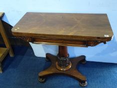 A William IV rosewood fold over card table, supported on turned central column and quadruple