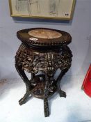 A finely carved Chinese hardwood two tier stand, with inset marble top, 32cm wide