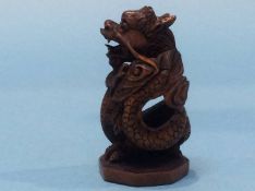 A carved netsuke in the form of a dragon