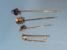 An 18ct gold trumpet brooch and three other pins