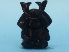 A carved netsuke in the form of a child