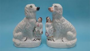 A pair of Staffordshire dogs with children standing at their sides, 31cm height