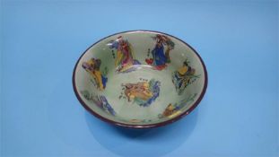 An Oriental bowl on a green ground, decorated with figures, 21cm diameter