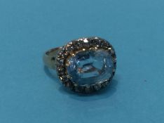 A ring set with aquamarine coloured stone and old cut diamonds, size M