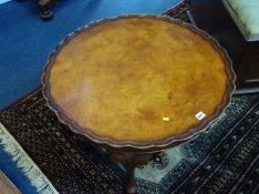 A walnut circular pad foot table, 75cm diameter