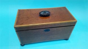 A 19th century mahogany tea caddy, with satinwood banding, supported on turned feet