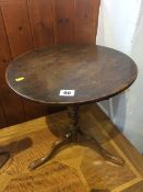 A miniature oak tilt top tripod table